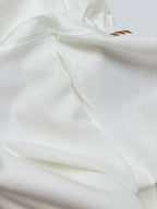 White T-shirt fabric close-up with stitched side seam.