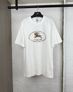 White short-sleeve T-shirt with Burberry logo patch on the chest.
