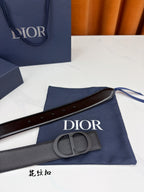 Dior belt with dark gray leather strap, circular buckle, and keeper loop