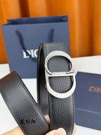 Dior belt close-up: textured dark leather strap with silver CD buckle.