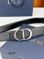 Dior belt close-up with silver CD buckle on dark leather strap.