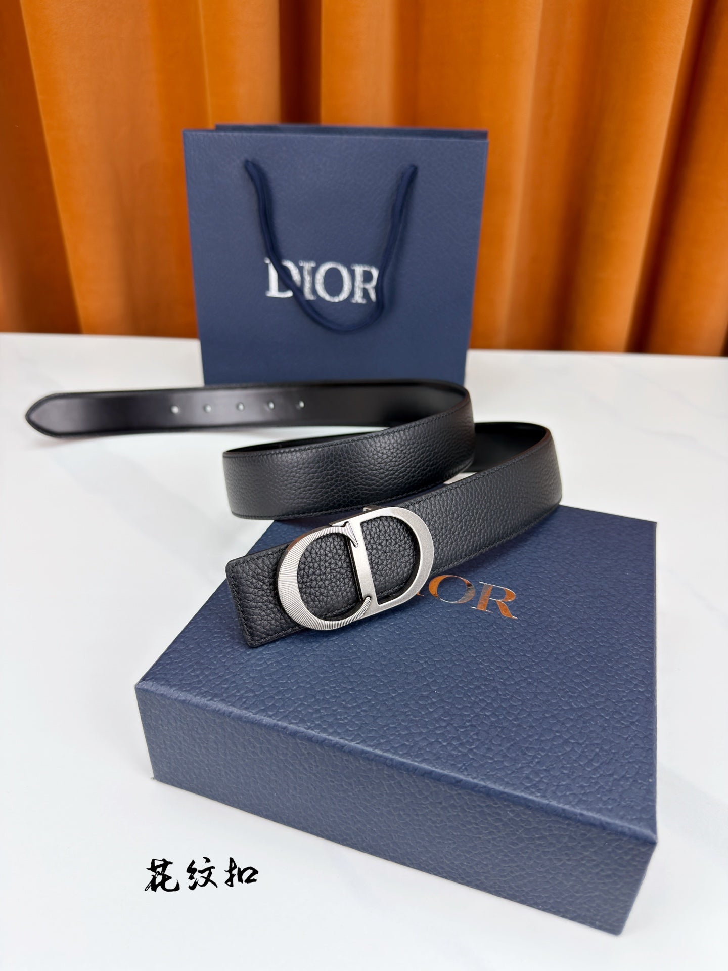 Dior belt in dark leather with silver CD buckle and visible buckle loop.