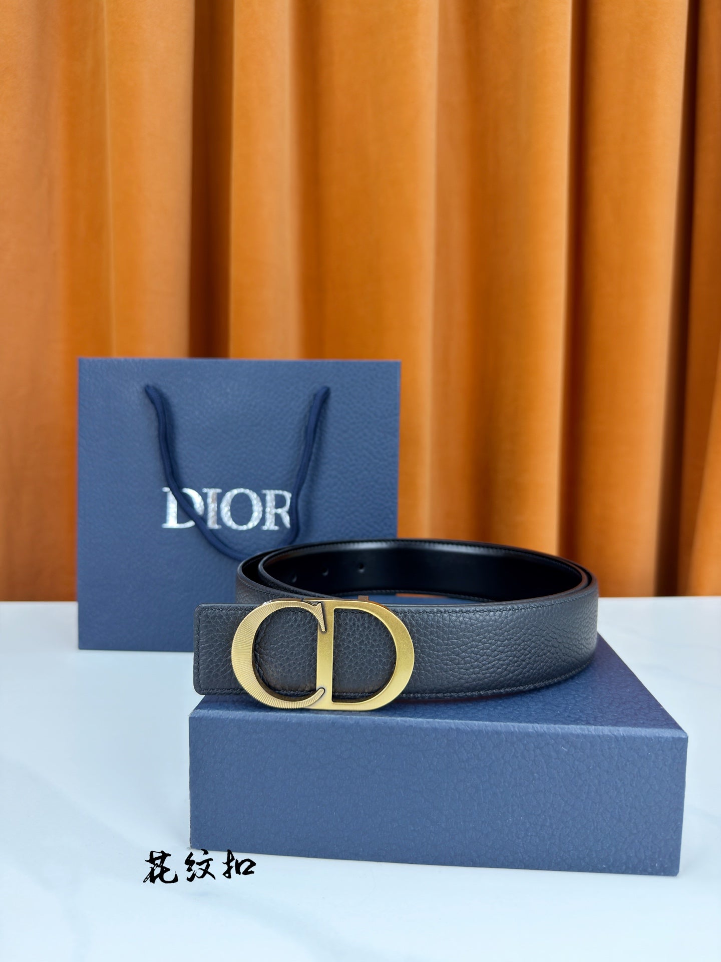 Dior belt in dark leather with gold CD buckle and metal loop.