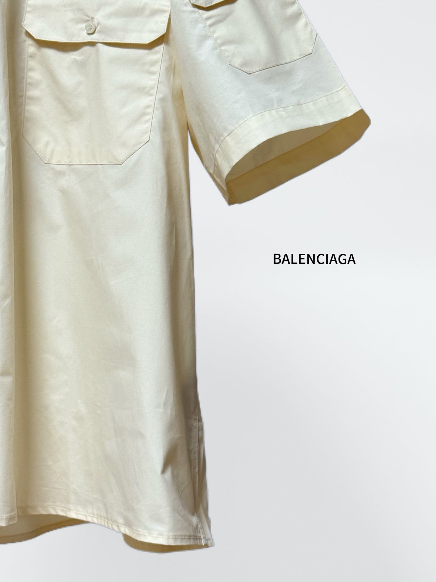 Balenciaga cream short-sleeve shirt with flap chest pockets and short sleeve cuffs.