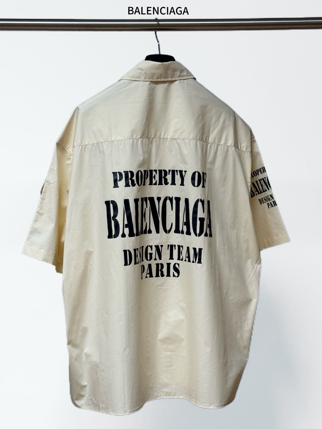 Cream short-sleeve button-up shirt, back graphic text and relaxed collar