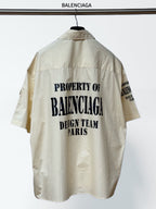 Cream short-sleeve button-up shirt, back graphic text and relaxed collar