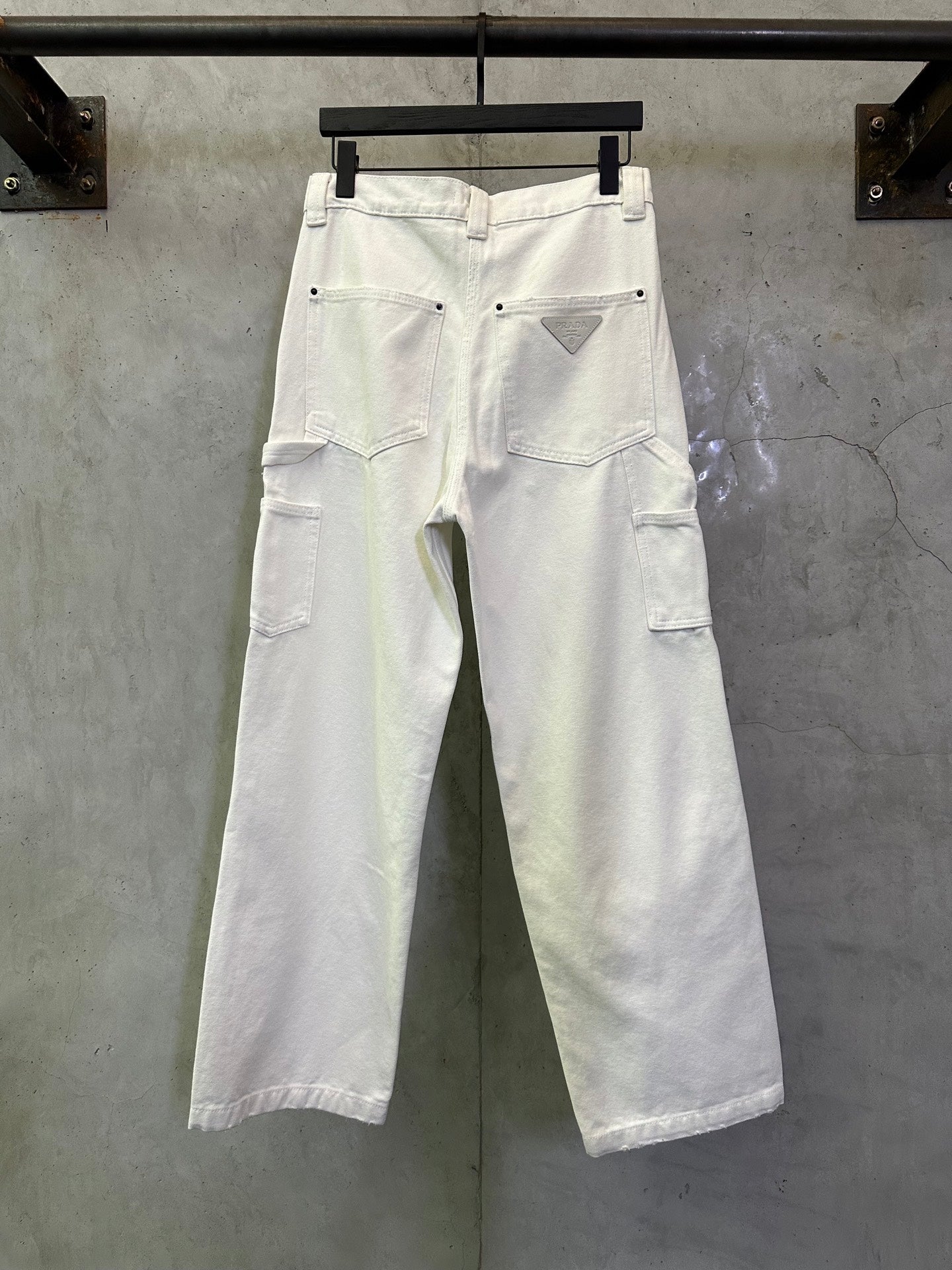 Prada white cargo pants showing back pockets and belt loops