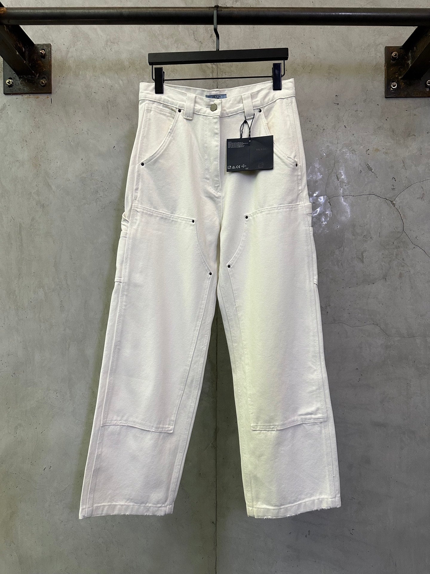 Prada white cargo pants with front pockets and button closure