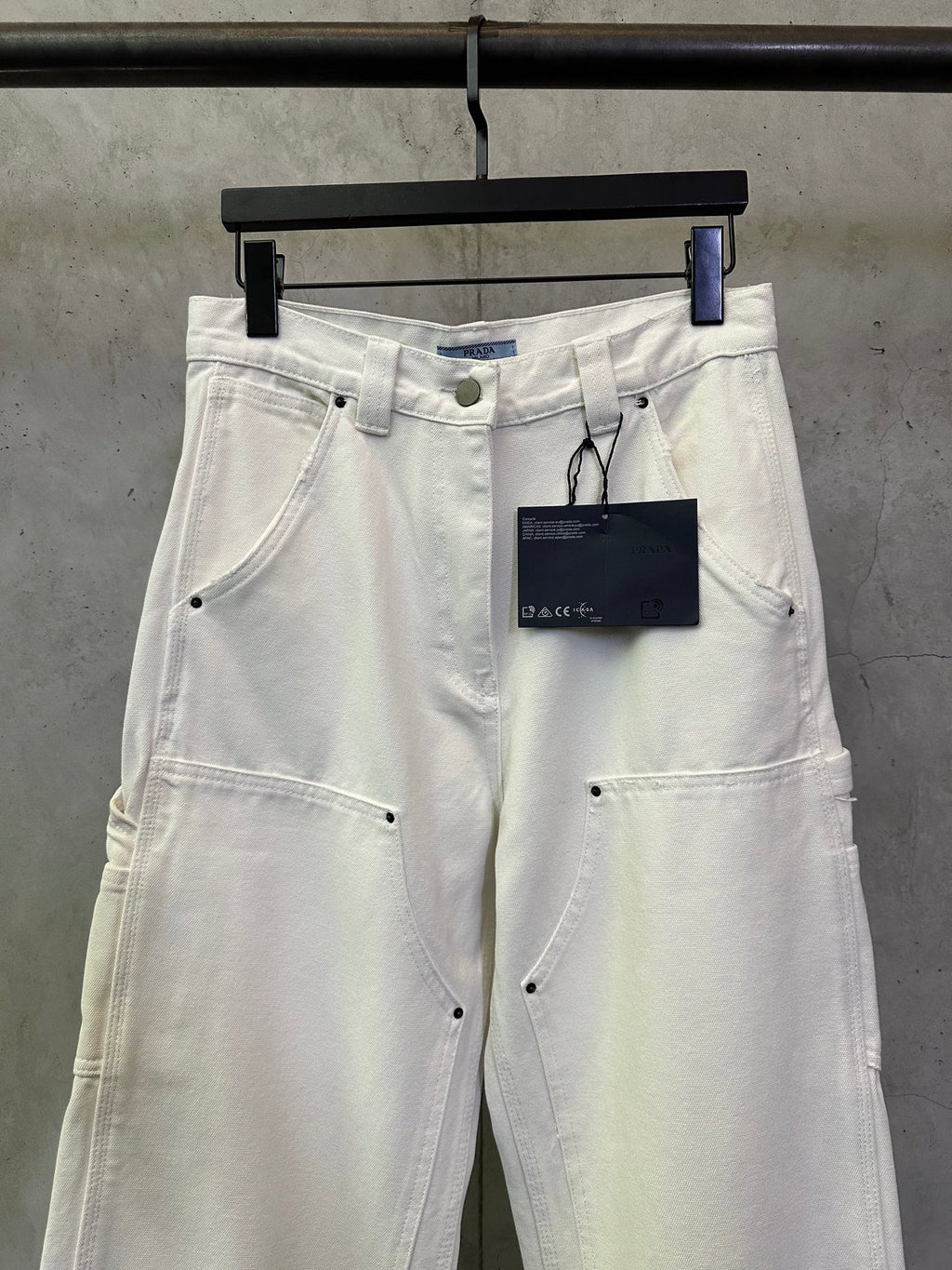 Prada white cargo pants front view with hanging brand tag