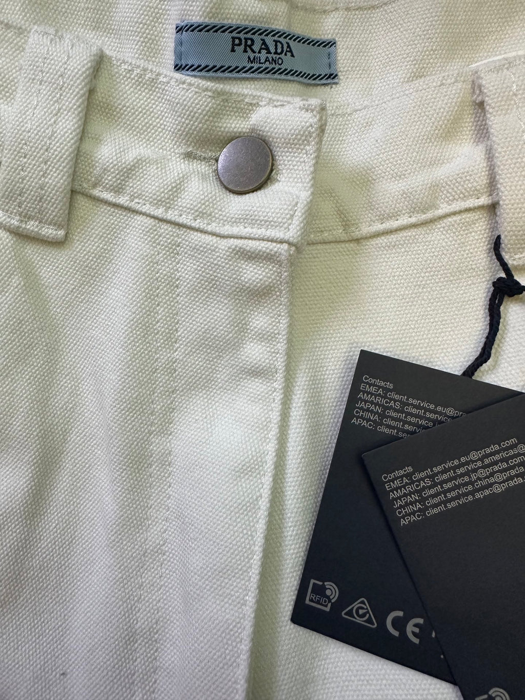 Prada white pants waistband with brand label, metal button, care tags
