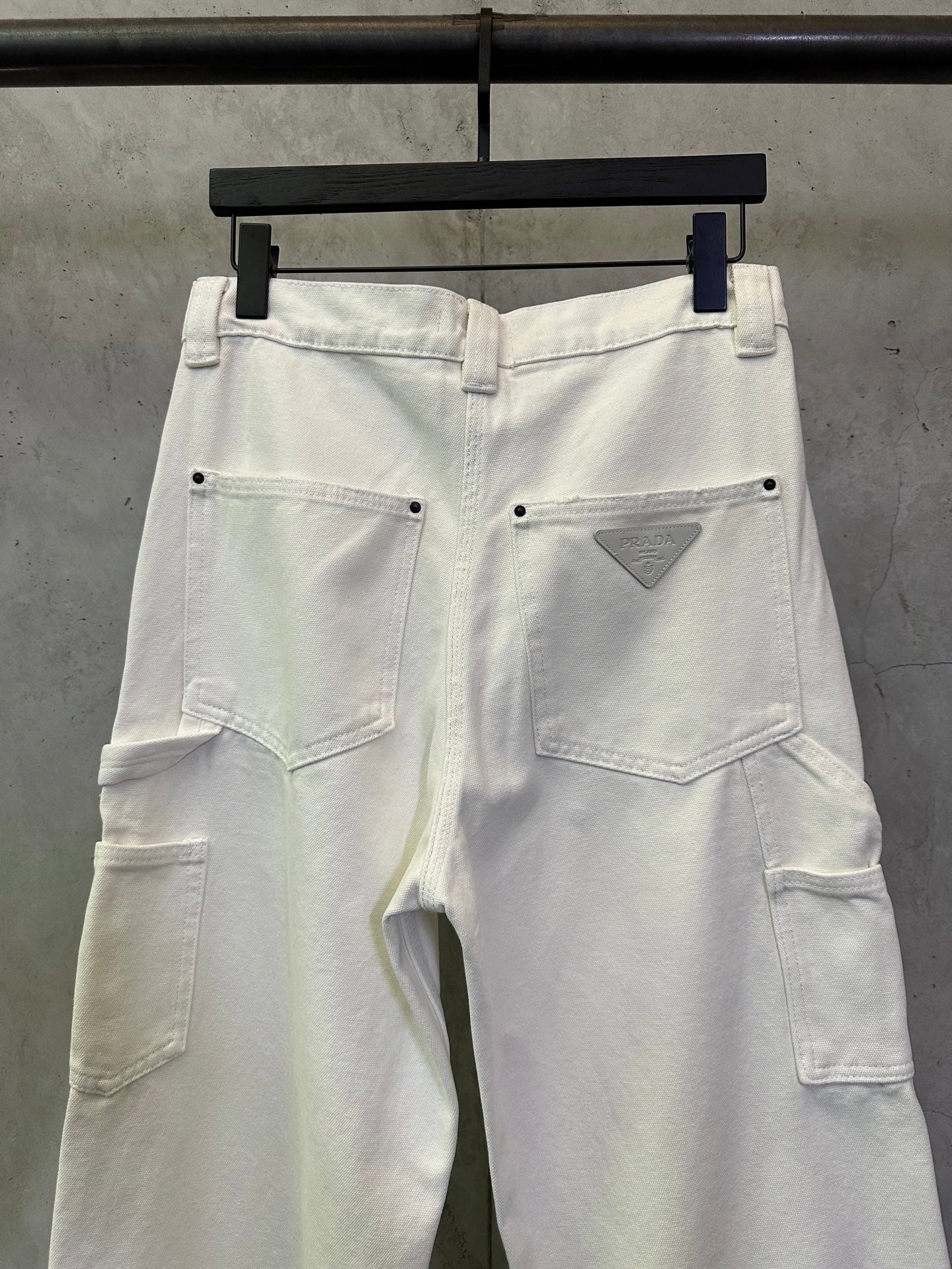 Prada white cargo pants with waistband button and triangular logo patch
