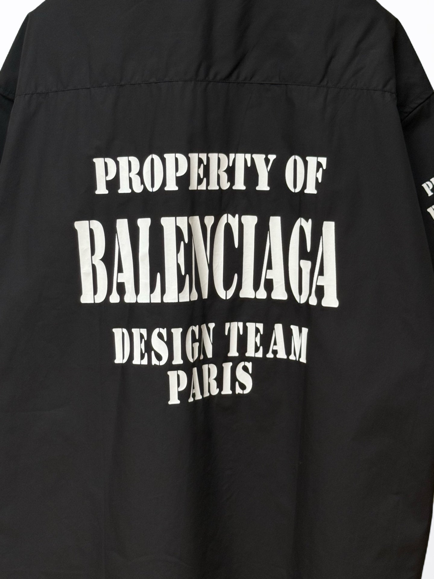 Balenciaga black short-sleeve shirt back close-up with “PROPERTY OF BALENCIAGA” text