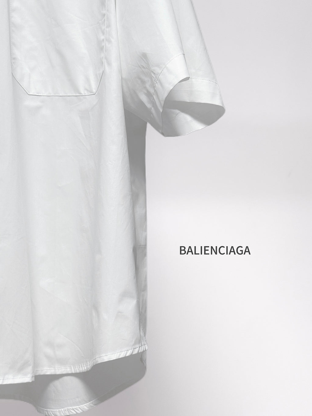 Balenciaga white short-sleeve button shirt sleeve and curved hem detail
