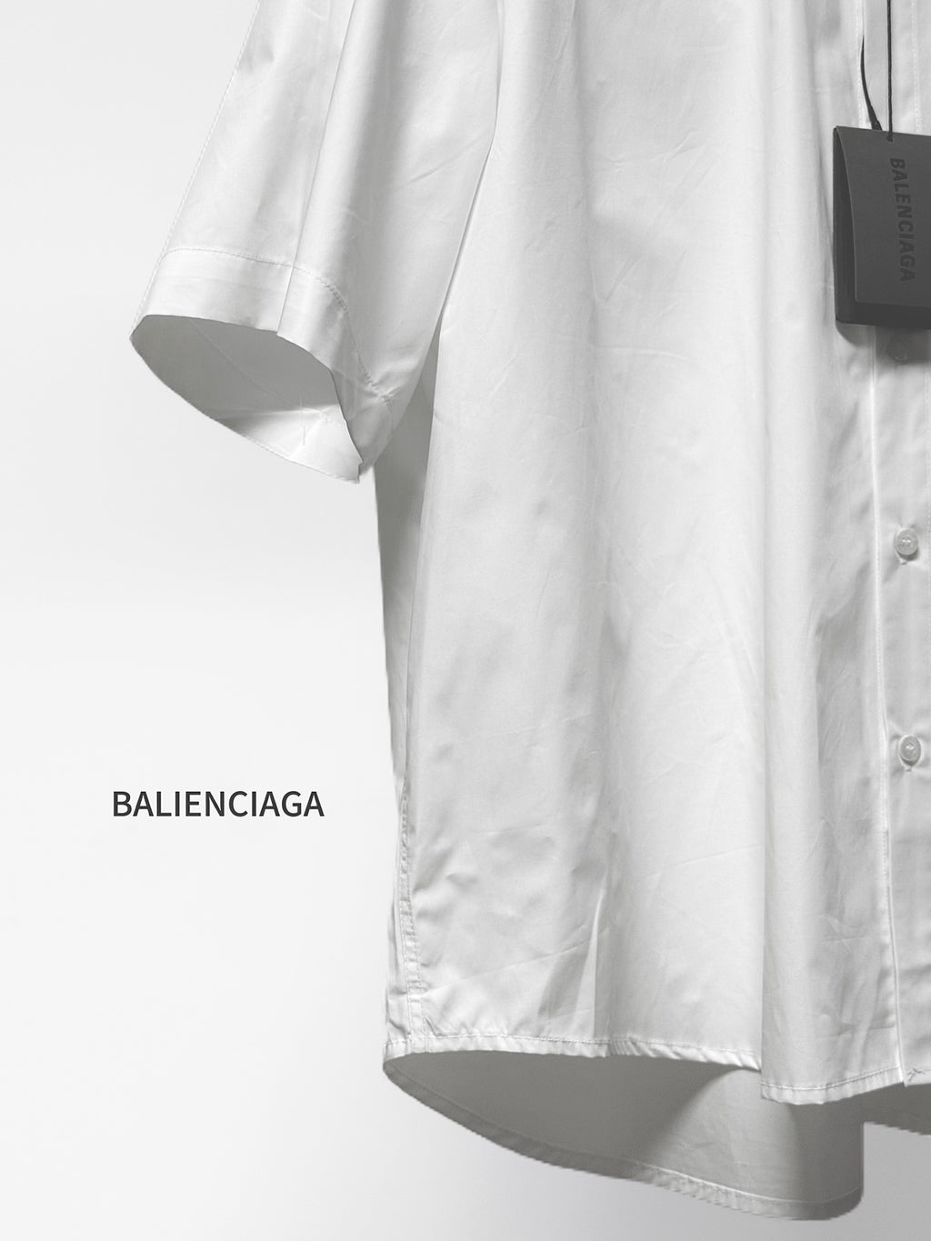 Balenciaga white short-sleeve button shirt with curved hem and button front
