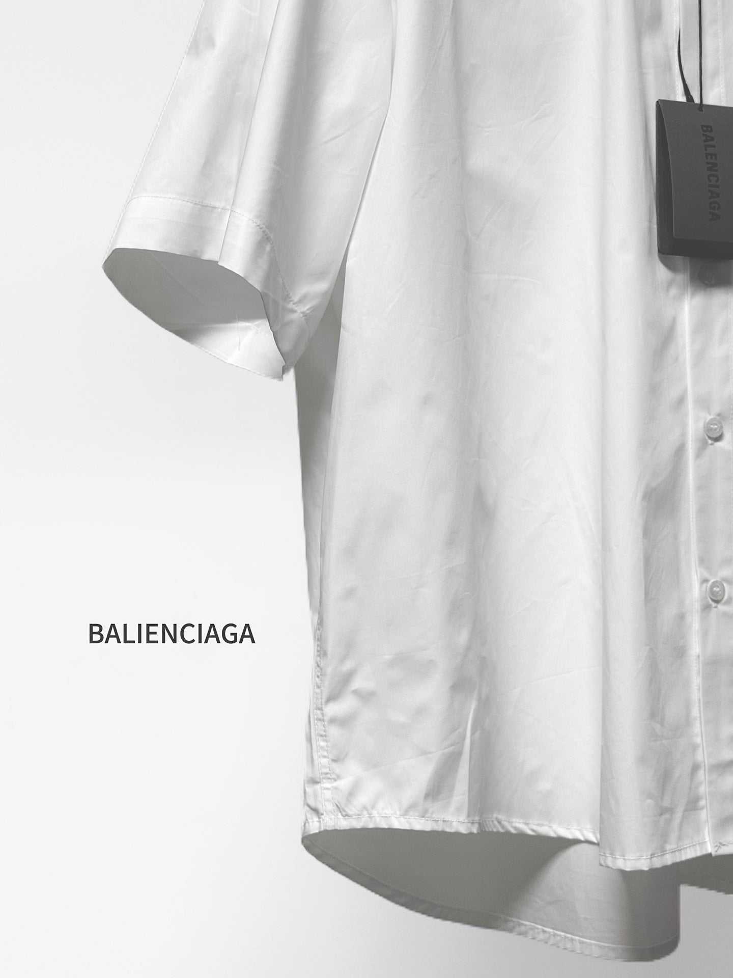 Balenciaga white short-sleeve button shirt with curved hem and button front