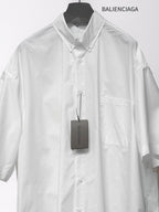 Balenciaga white short-sleeve button-up shirt with chest pocket, front buttons, and tag