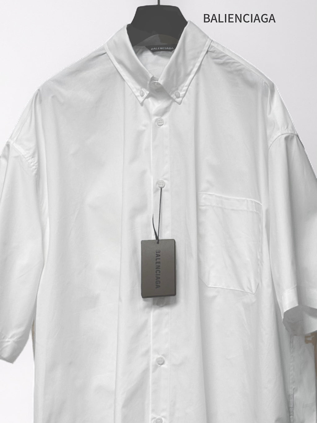 Balenciaga white short-sleeve button shirt with chest pocket and buttoned front