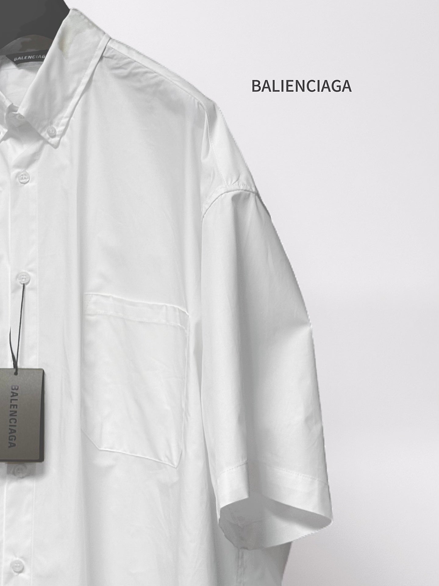 Balenciaga white long-sleeve button-up shirt, side view with chest pocket