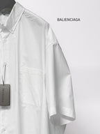 Balenciaga white short-sleeve shirt side view with chest pocket and hanging tag