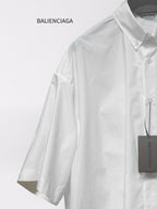 Balenciaga white short-sleeve button-up shirt close-up of shoulder, sleeve, and tag