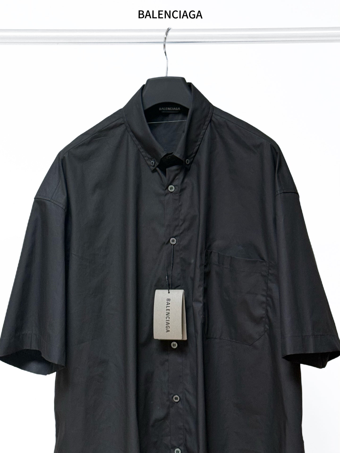 Black short-sleeve shirt, button-front and point collar with chest pocket