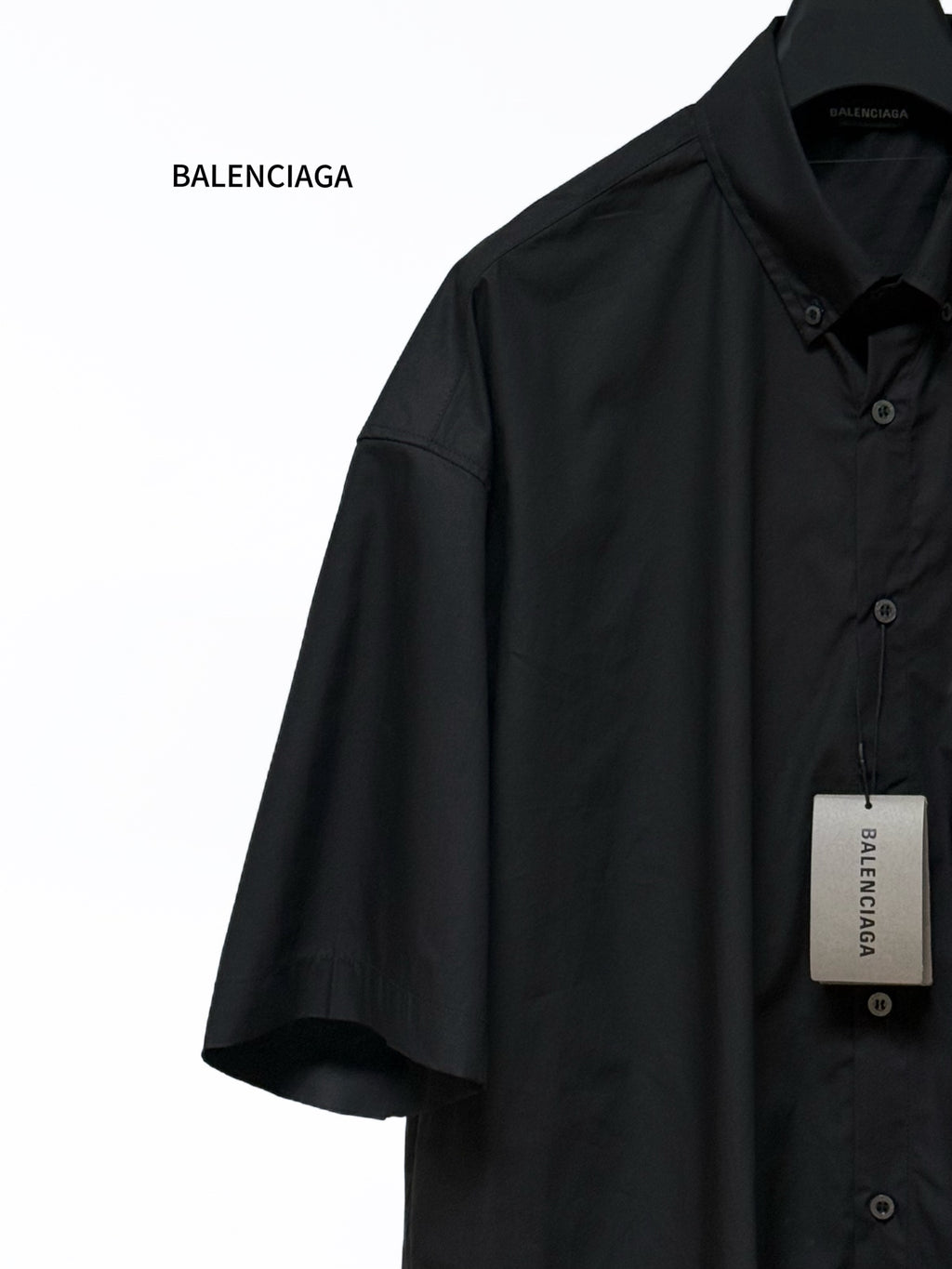Black short-sleeve shirt with button placket and point collar, side view