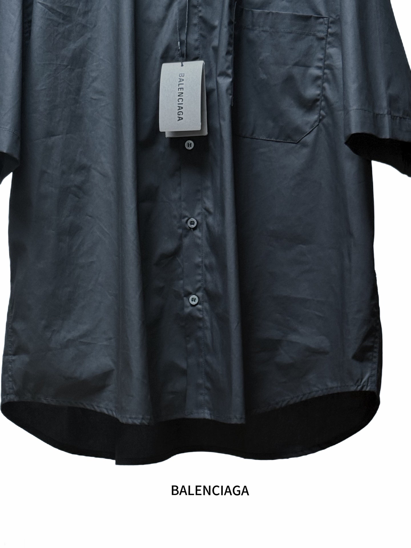 Men's short-sleeve button-up shirt, black, front close-up with buttons and chest pocket