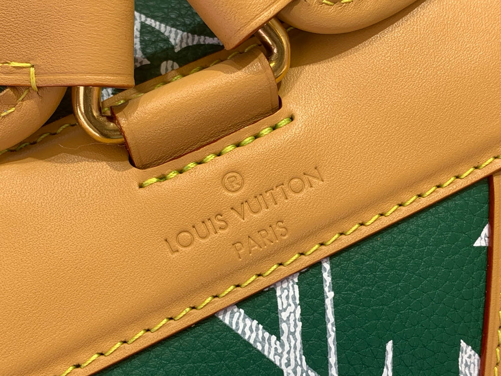 Louis Vuitton tan leather strap detail with stitched edging and engraved brand text