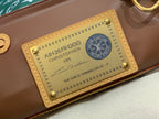Louis Vuitton luggage tag on brown leather base with printed text and round seal