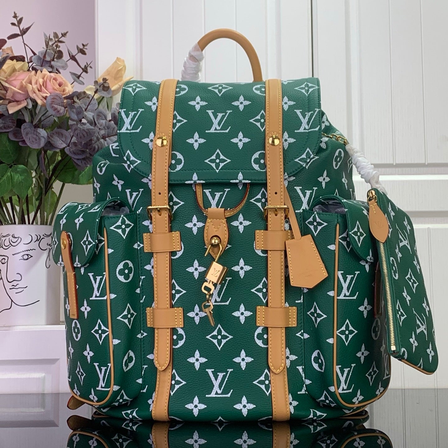 Louis Vuitton patterned handbag in dark green with white monogram and tan leather straps