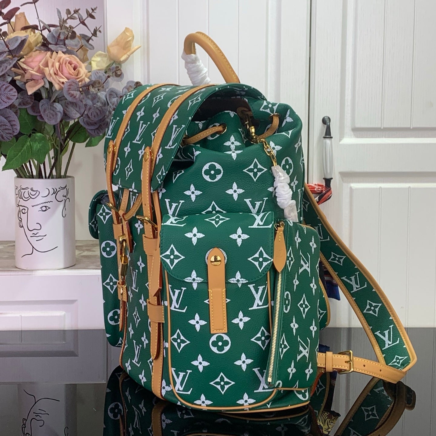 Louis Vuitton patterned handbag with dark green body, white monogram, and top handle