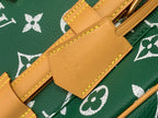 Louis Vuitton tan leather strap tab with engraved brand and gold rivets on green monogram