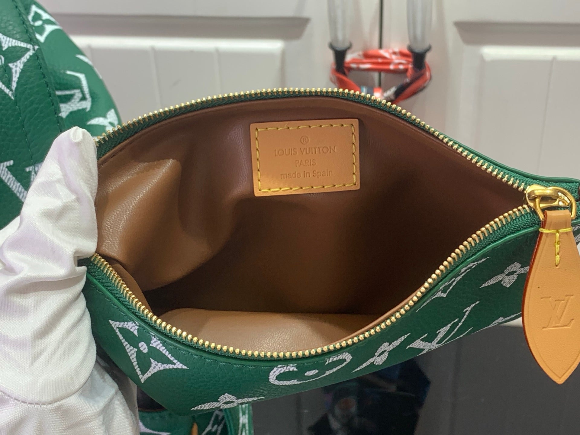Louis Vuitton monogram handbag interior with brown lining and gold zipper hardware