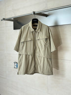 Beige short-sleeve utility jacket with pointed collar and front zipper