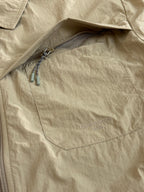 Beige Louis Vuitton jacket chest pocket with zipper opening and embossed logo
