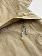 Beige Louis Vuitton jacket with mesh-lined pocket opening and drawstring pulls