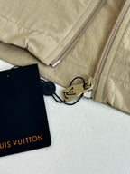 Beige Louis Vuitton jacket sleeve area with zippers and hanging leather tags