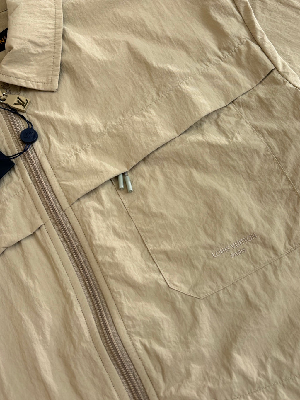 Beige Louis Vuitton jacket with zip front and small chest logo detail