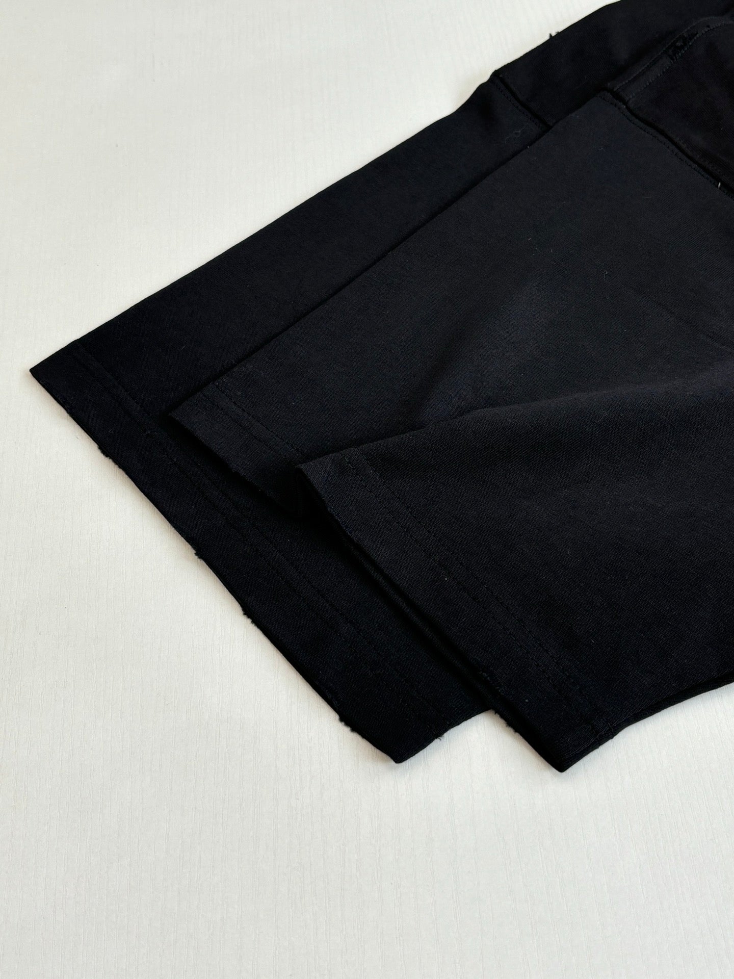 Balenciaga black T-shirt sleeve and hem, laid flat