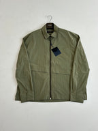 Olive green jacket with zip front, stand collar, and chest flap pockets.