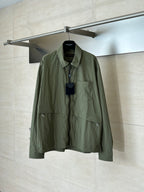Olive green long-sleeve jacket with button-front placket and chest pockets.