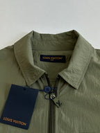 Olive green jacket collar with front zipper and Louis Vuitton label tag.