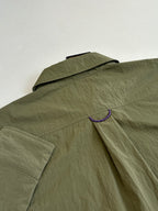 Olive long-sleeve jacket with flap collar and purple trim detail