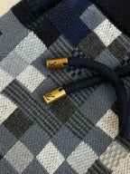 Louis Vuitton drawstring tips and cord on checkered shorts, gold aglets on navy cord