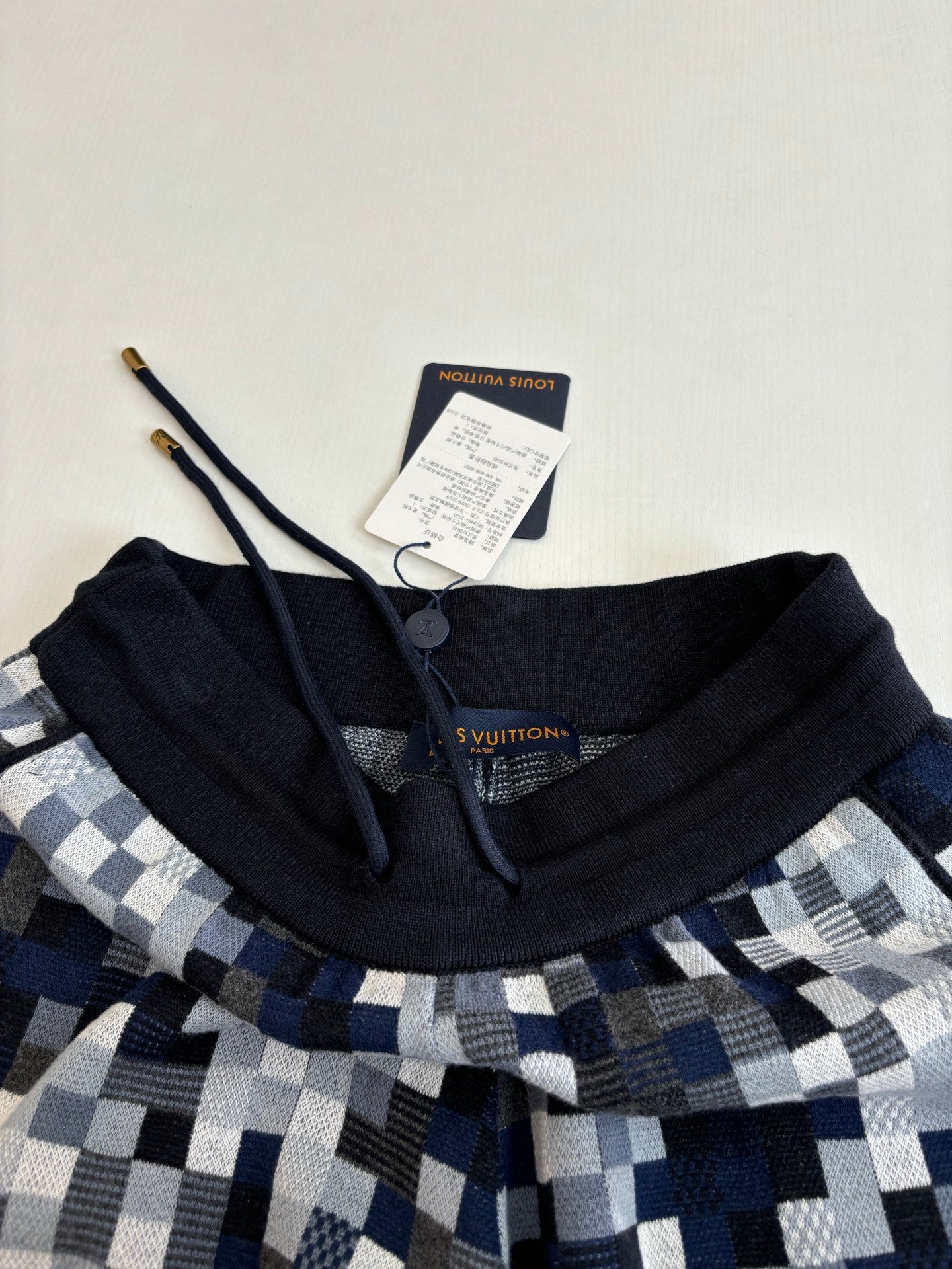 Louis Vuitton shorts neckline detail with black drawstring waistband and size tag