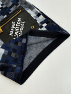 Louis Vuitton shorts close-up: black trim, blue-gray check pattern, logo pocket corner
