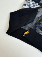 Sleeve and hem corner of check knit zip sweater jacket with gold zipper hardware