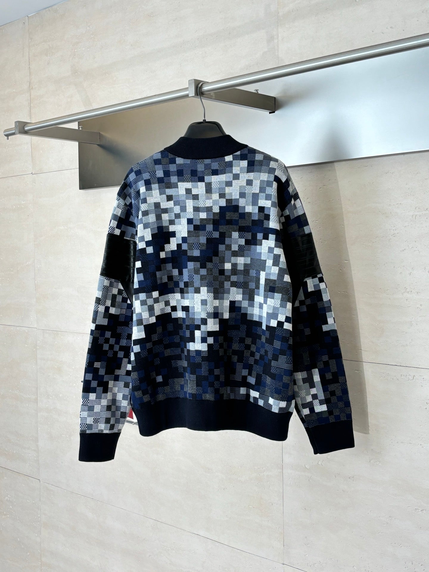 Back view of blue and white pixel check zip sweater jacket with black rib trim