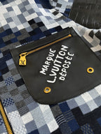 Front patch detail on blue-and-white check zip sweater jacket with gold zipper pull
