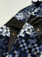 Check knit sleeves with black leather-look panels and gold snap buttons